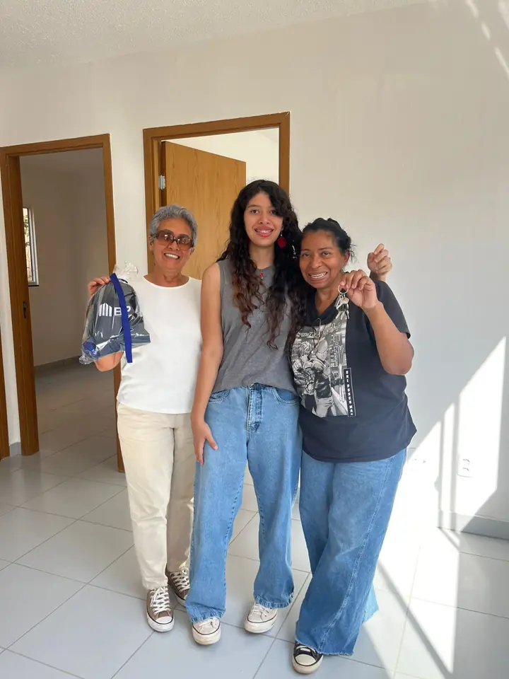 Três moradoras comemorando a entrega das chaves do bp