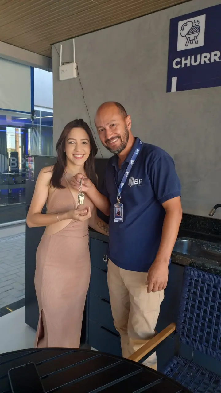 Moradora recebendo as chaves de um consultor da bp